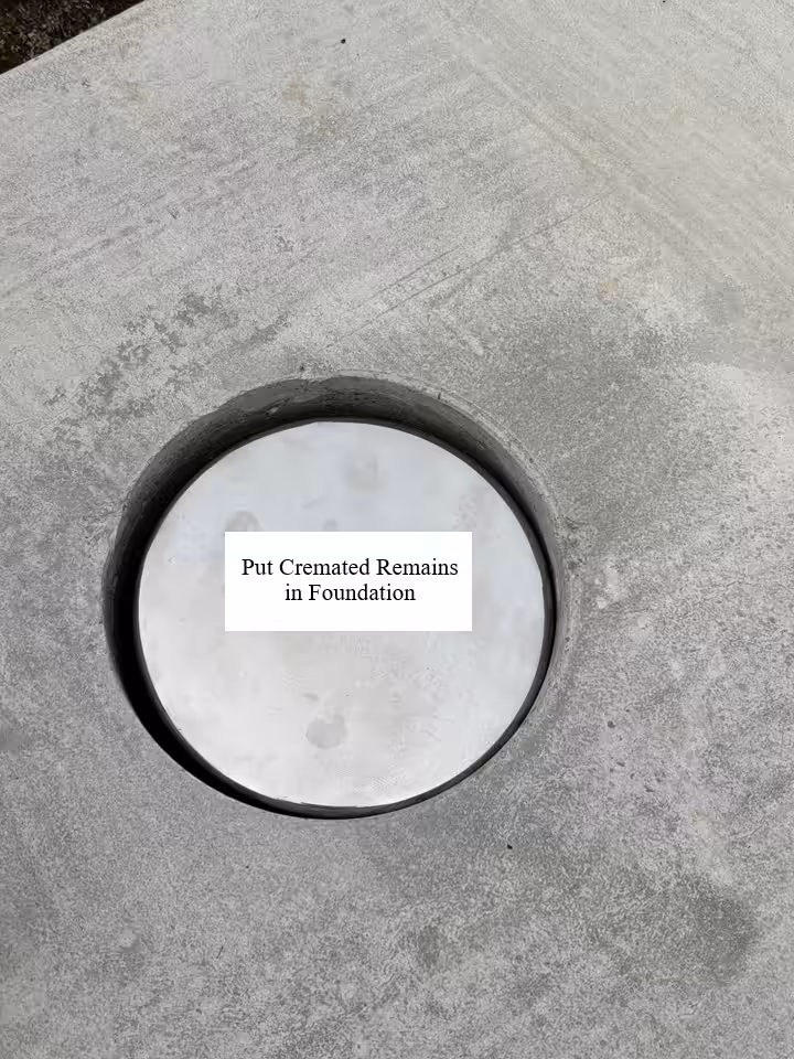 circular metal cap set into a concrete memorial foundation
